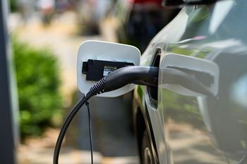 An electric car is plugged into a charging station.